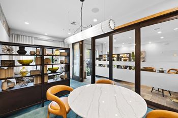 a dining room with a table and chairs and a display case