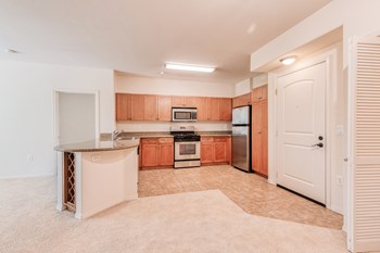 Kitchen with stainless steel appliances and built-in wine rack - Photo Gallery 4
