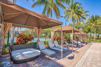 a pool with lounge chairs and umbrellas - Photo Gallery 19