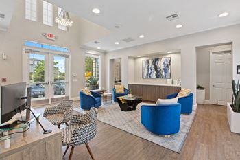a living room with couches and chairs and a tv