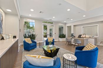 the preserve at ballantyne commons community living room with blue chairs and tables