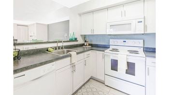 Kitchen With White Cabinetry And Appliances at Windsor Coconut Creek, Coconut Creek, FL, 33073