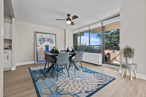 A dining room with a table set for four.