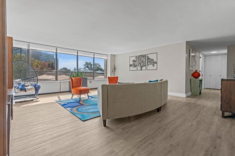 A living room with a couch, chair, and a table.
