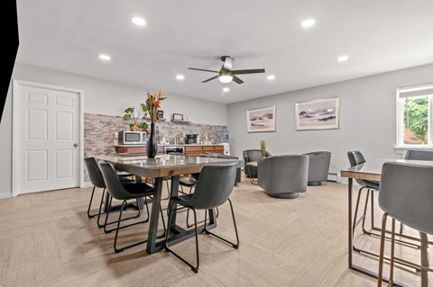 A dining room with a table and chairs.