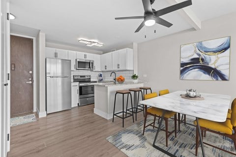 A modern kitchen with a dining table and chairs.