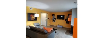 a living room with a couch and a tv