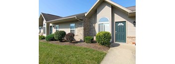 the front of a house with a green door