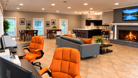 A modern living room with orange chairs and a fireplace.