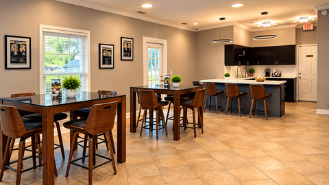 A kitchen with a table and chairs in the middle of the room.