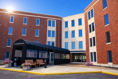 A sunny day at the 11 West Ave building entrance.