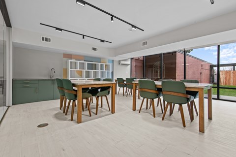 A modern dining room with a wooden table and chairs.