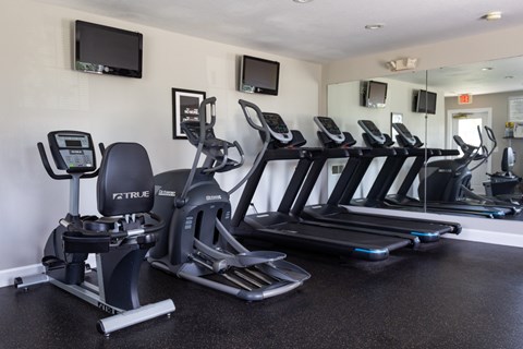 A gym with treadmills and exercise bikes.