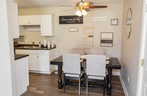 A kitchen with a table and chairs in the middle of the room.
