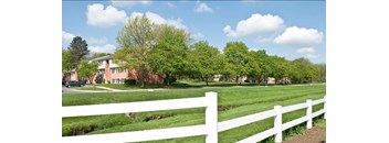 our apartments are located in a quiet neighborhood with a white fence