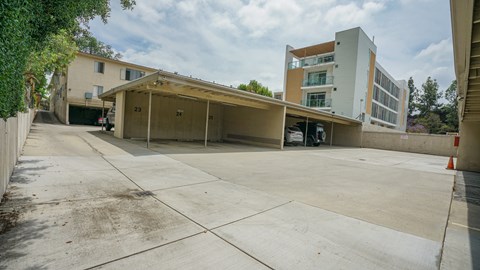 A parking lot with a building in the background.