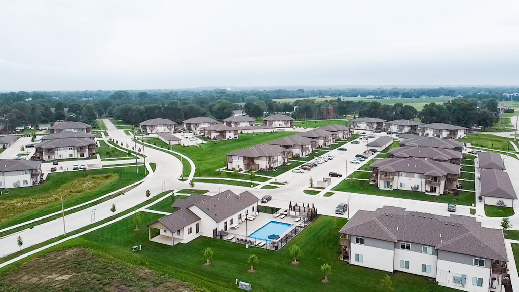an aerial view of a neighborhood of apartments with a swimming pool