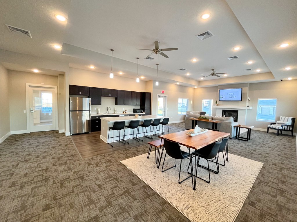 a large living room with a dining room table and a kitchen