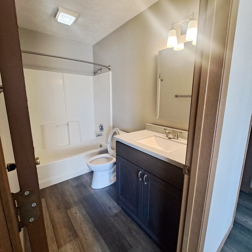 an empty bathroom with a sink toilet and shower