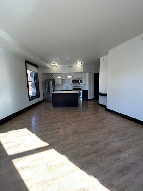 A kitchen area with a counter and a fridge.