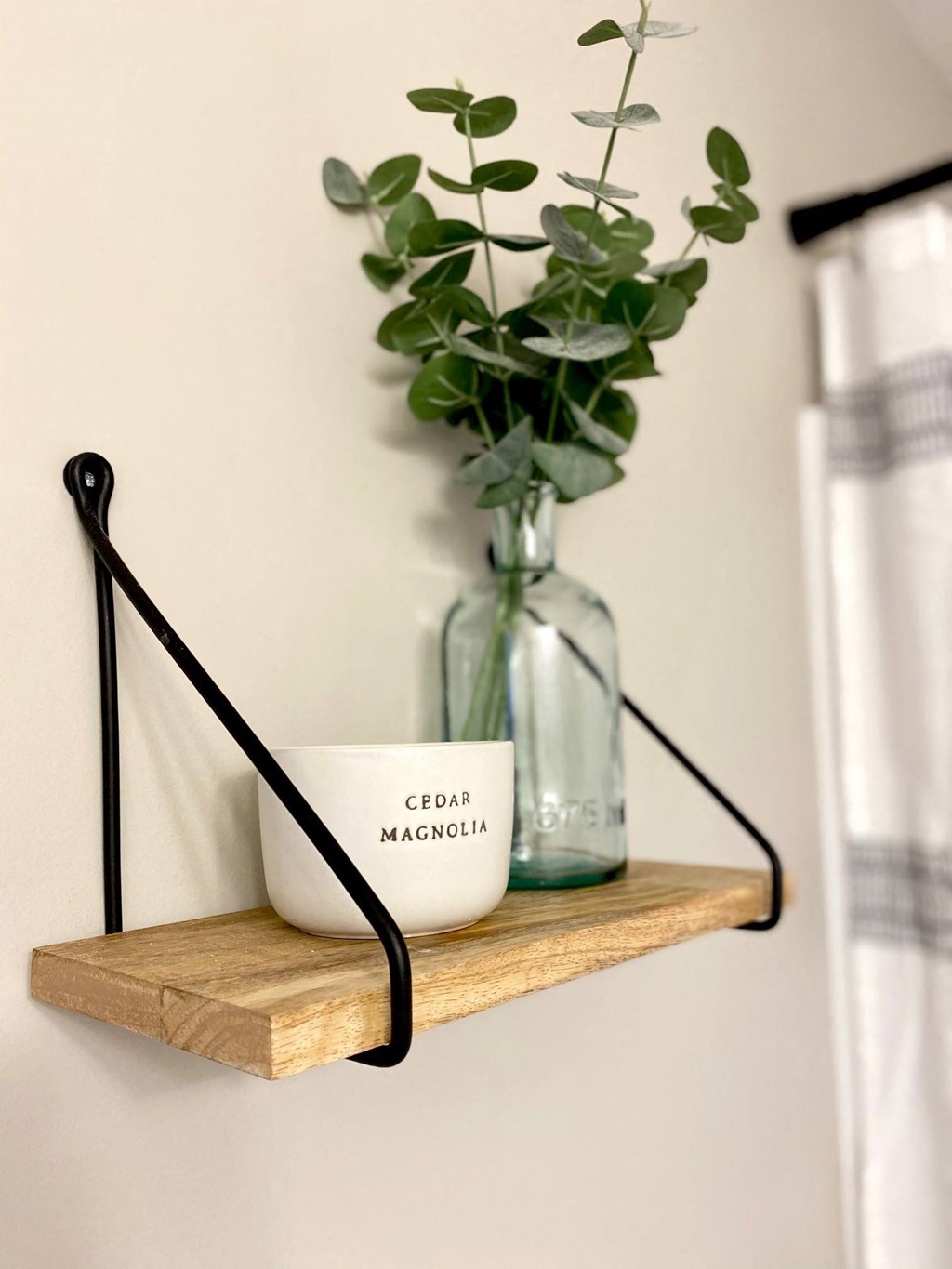 Bathroom shelf magnolia candle eucalyptus in blue glass jar