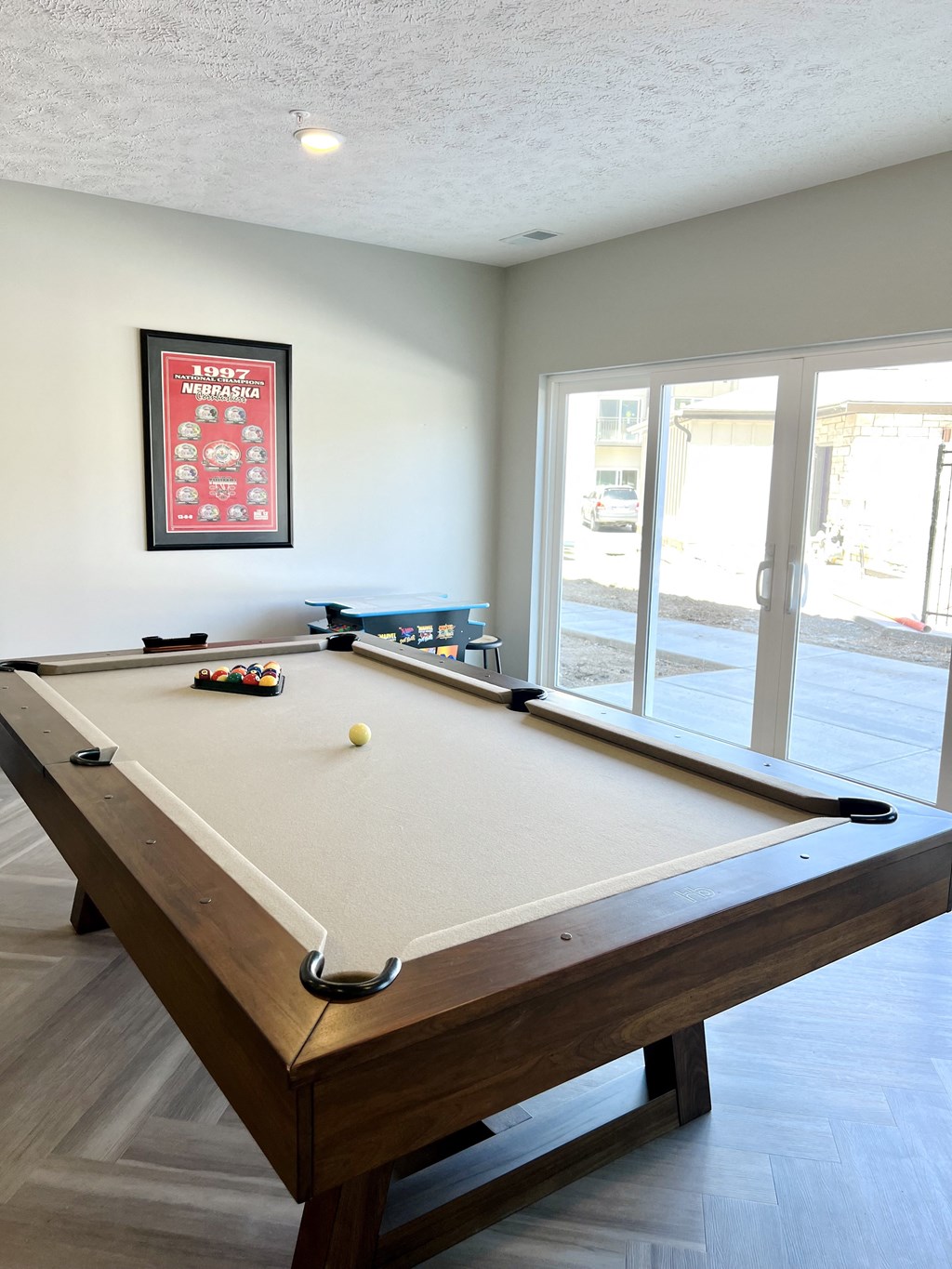 a pool table in a game room with a view of the patio