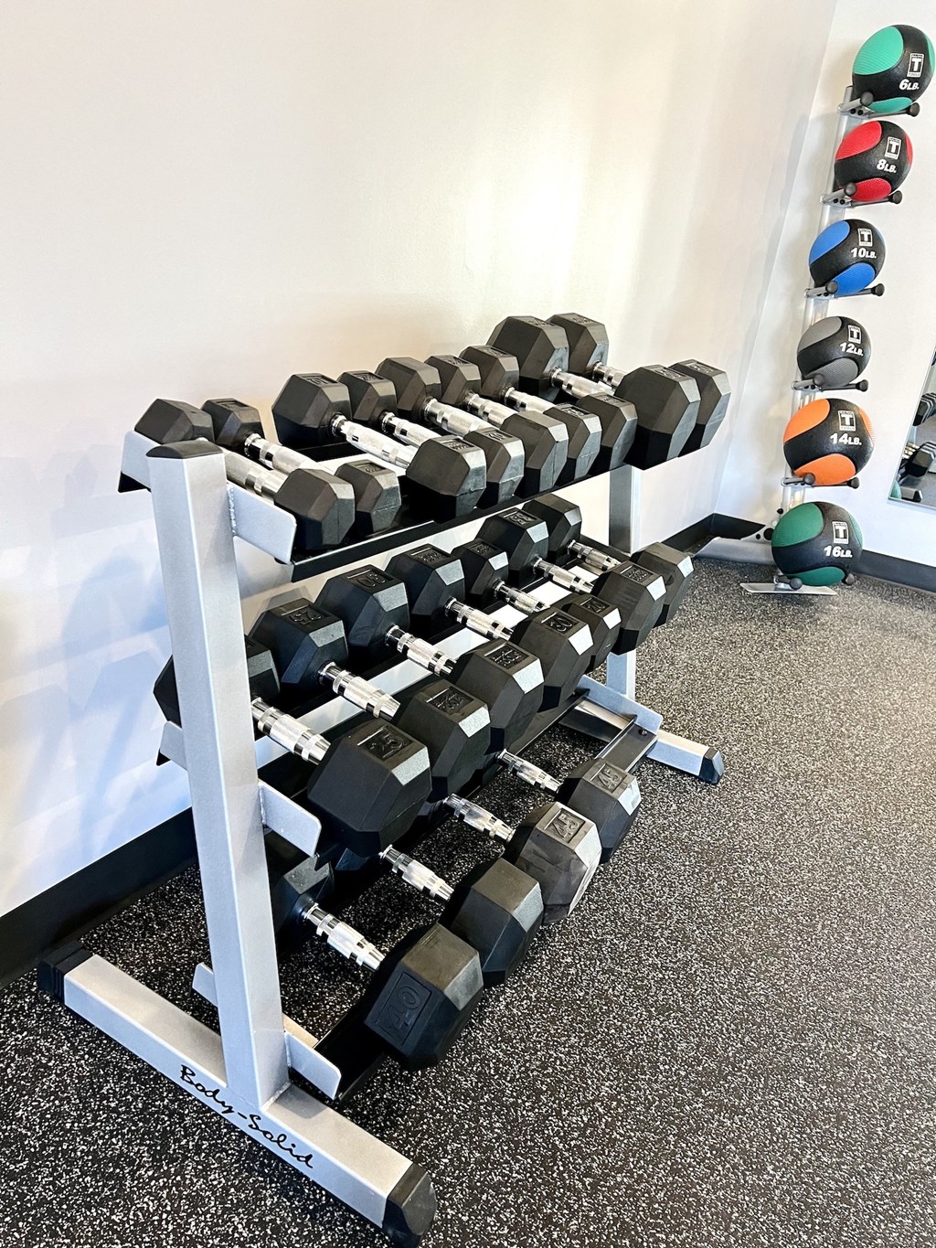 a row of weights on a rack in a gym