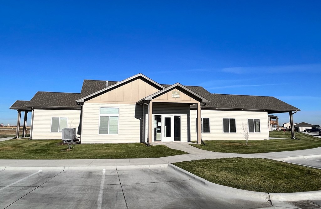 a white house with a porch and a driveway