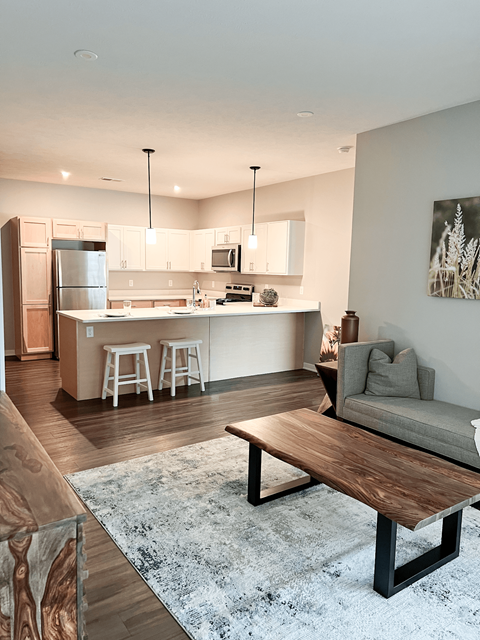 a living room and kitchen with a couch and a table