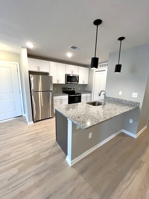 a kitchen with granite counter tops and stainless steel appliances