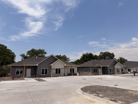 A row of new houses are being built in a suburban area.