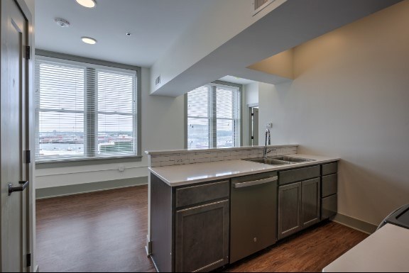 A kitchen with a large island and stainless steel appliances.