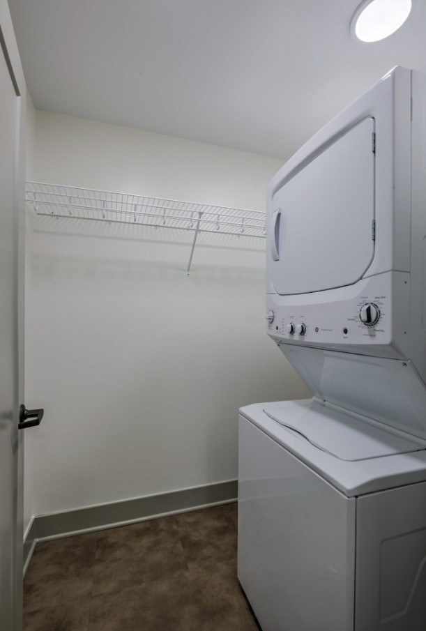 A white washing machine in a small laundry room.