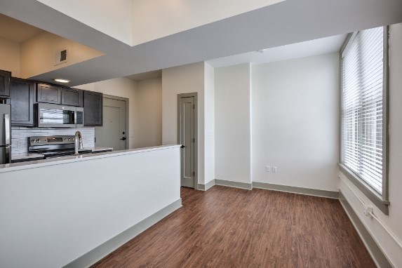 A kitchen with dark wood cabinets and a white countertop.