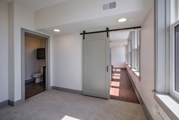 A room with a toilet and a sliding door.