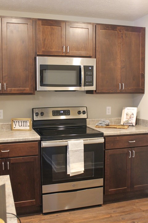 a kitchen with stainless steel appliances and wooden cabinets