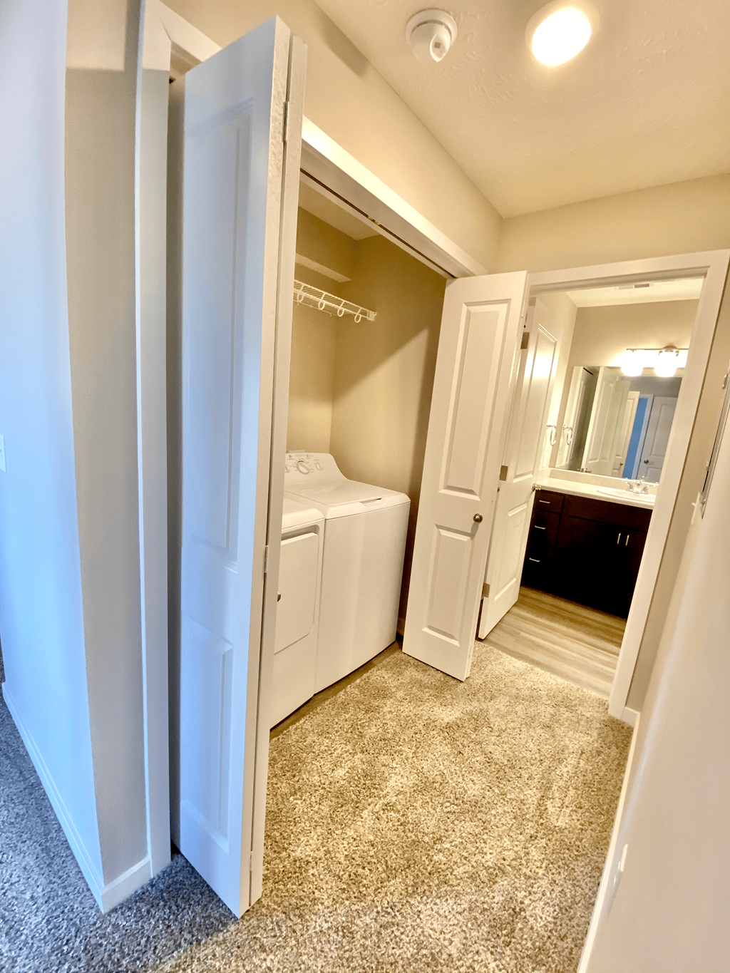 a bathroom with a washer and dryer and a closet