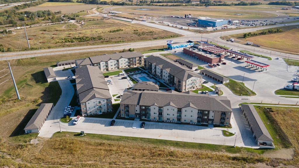 A large building complex with a parking lot in front.