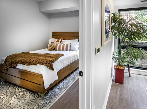 a bedroom with a bed and a large window