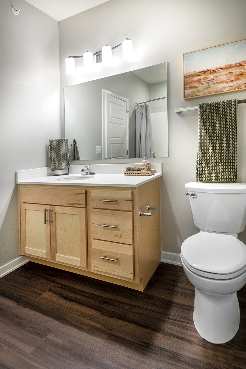A white toilet sits next to a sink in a bathroom.