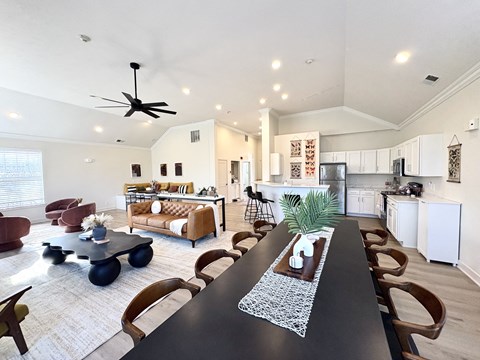 A modern dining room with a long table and chairs.