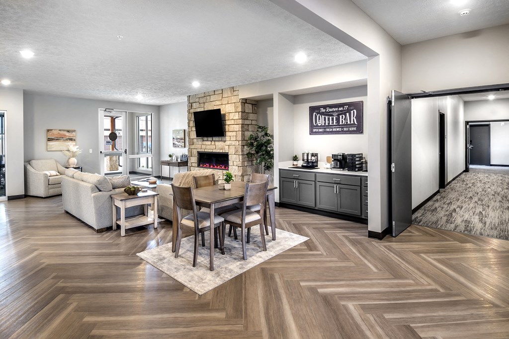 A modern living room with a coffee bar and a fireplace.