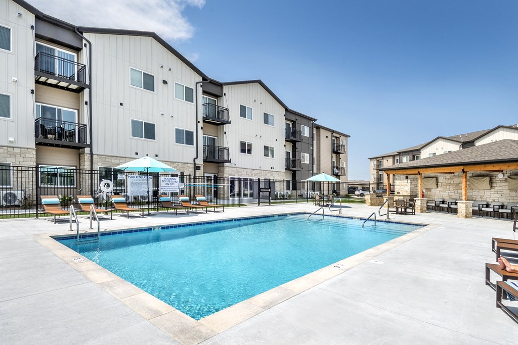 A swimming pool in front of apartment buildings.