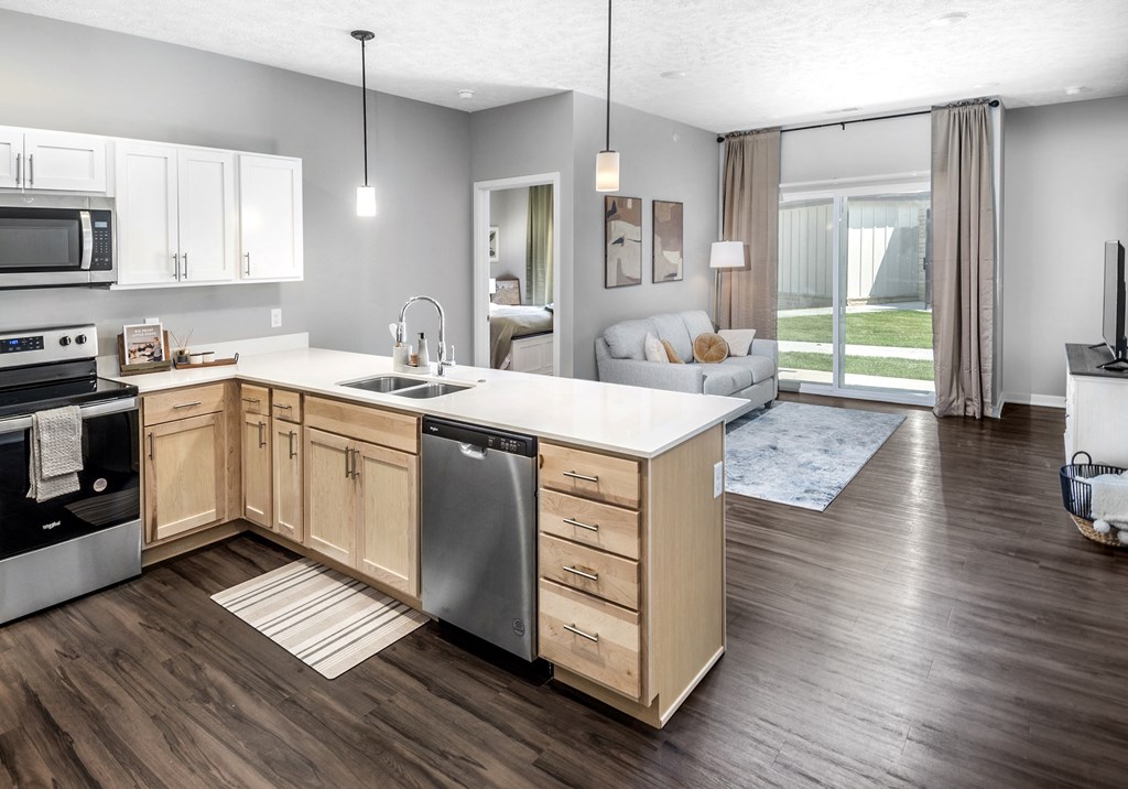 A modern kitchen with wooden cabinets and a large island.