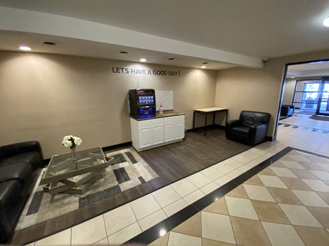 a lobby with a table and chairs and a tv