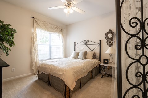 A functional bedroom in a two-bedroom apartment at Enclave at Town Center, with room for furniture and storage.