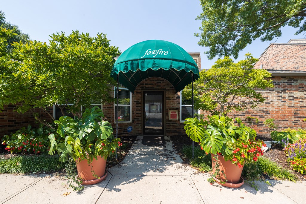 A welcoming clubhouse with a classic brick exterior and well-kept landscaping.