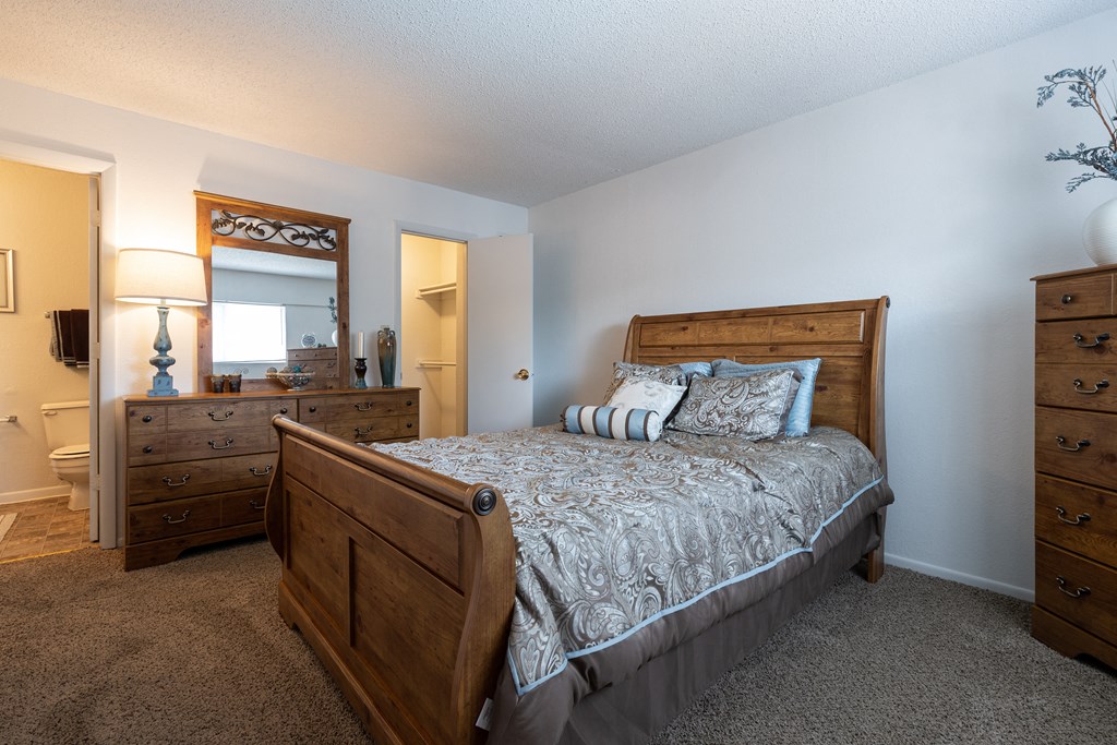 A comfortable sleeping space with soft lighting and plush carpeting.