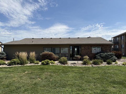 Fox Run Apartments office building in Omaha, Nebraska with brown roof and green lawn