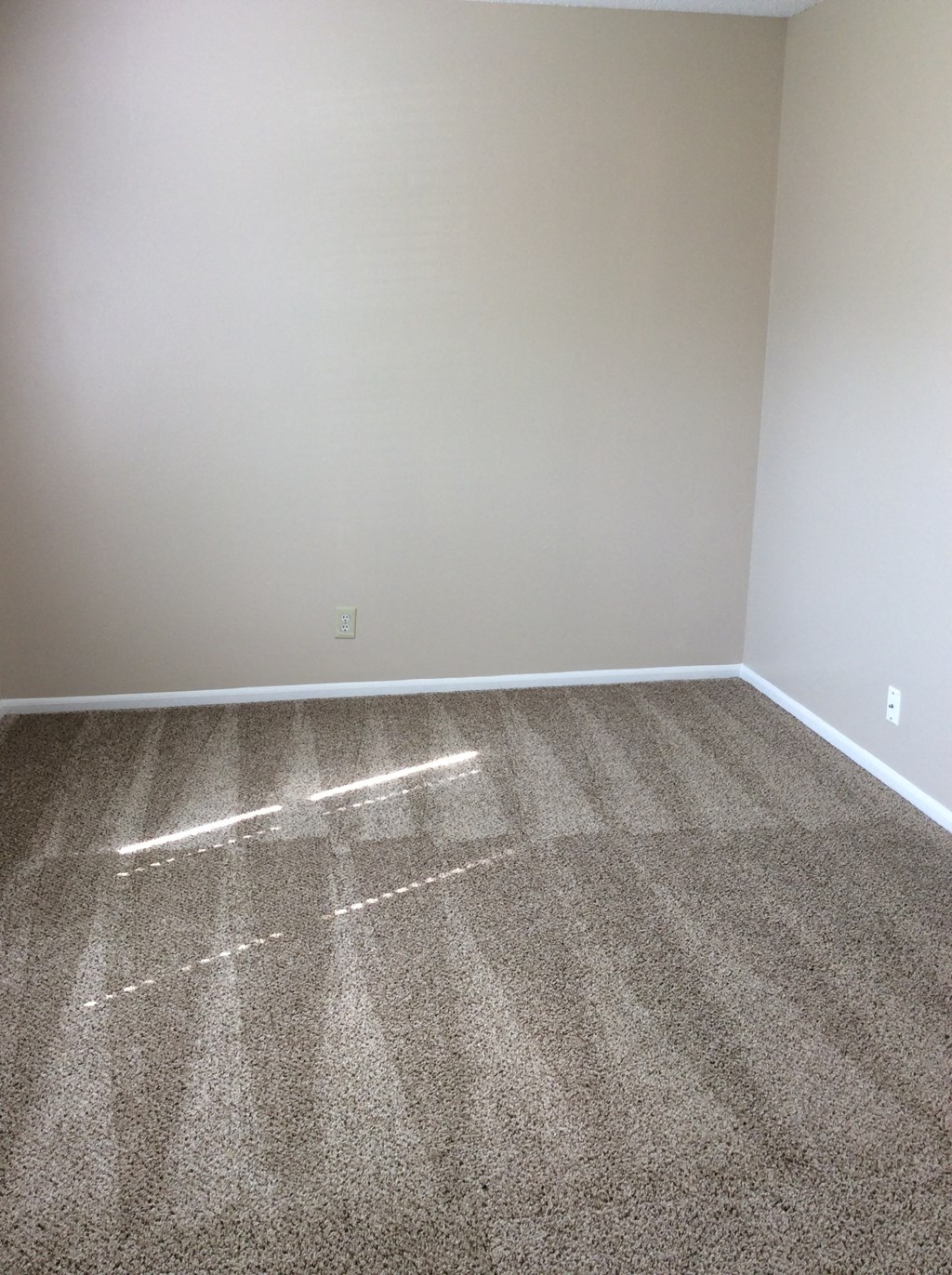 Bedroom in the Yeakel Townhome, featuring a carpeted floor and a wall.